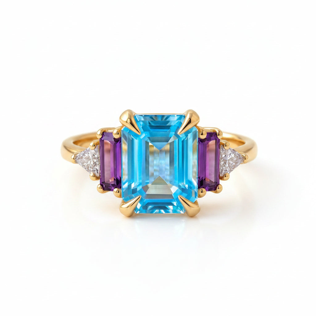 Gold ring with blue gemstone on a textured fabric background
