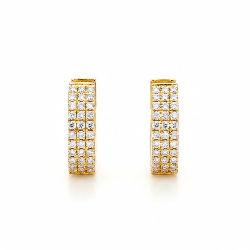 A pair of gold huggie hoop earrings paved with small clear cubic zirconia stones, shown from front and side angles on a white background with a faint watermark pattern.
