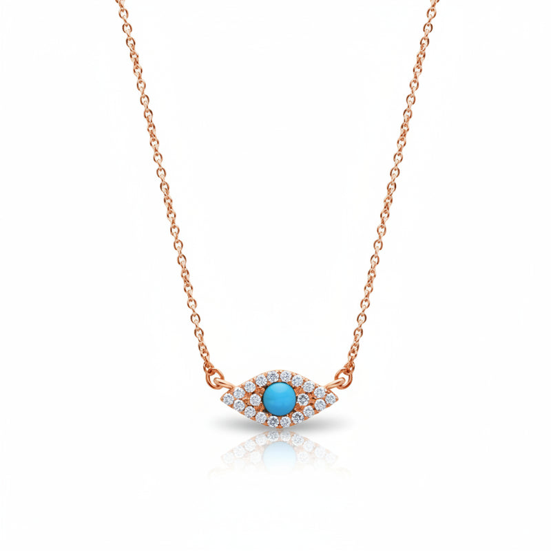 A rose gold necklace with an evil eye pendant featuring a central turquoise blue stone surrounded by small clear stones, shown on a white background with a faint watermark pattern.