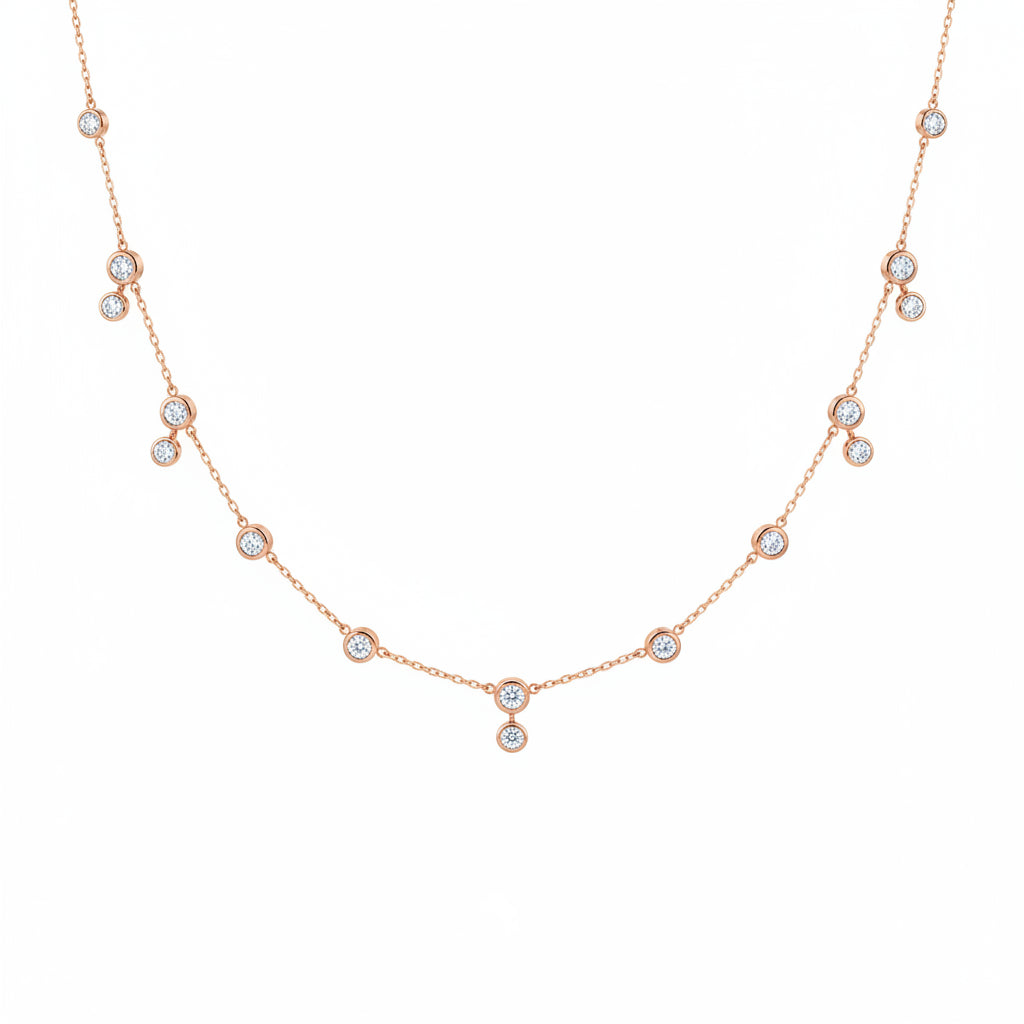 A delicate rose gold chain necklace featuring multiple small round bezel-set clear stones spaced along the chain, displayed against a white background with a faint diagonal watermark pattern.