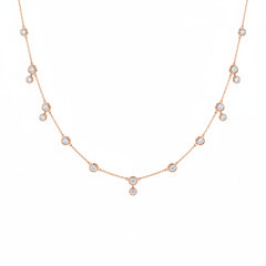 A delicate rose gold chain necklace featuring multiple small round bezel-set clear stones spaced along the chain, displayed against a white background with a faint diagonal watermark pattern.