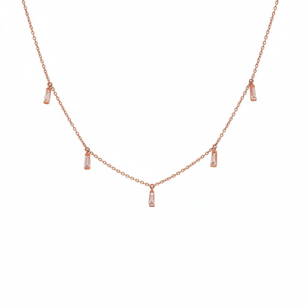 A rose gold necklace with a delicate chain and five small vertical baguette charms, each adorned with a clear rectangular gemstone, displayed on a white background with a diagonal watermark pattern.