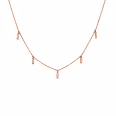 A rose gold necklace with a delicate chain and five small vertical baguette charms, each adorned with a clear rectangular gemstone, displayed on a white background with a diagonal watermark pattern.