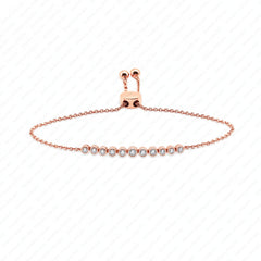 A delicate rose gold chain bracelet with a central row of small clear gemstones, displayed on a white background with a faint diagonal watermark pattern.