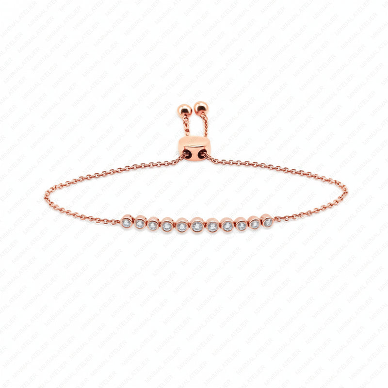 A delicate rose gold chain bracelet with a central row of small clear gemstones, displayed on a white background with a faint diagonal watermark pattern.