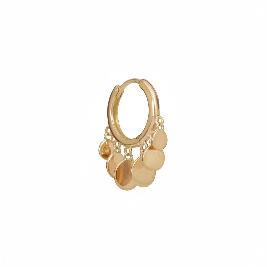 A gold huggie hoop earring with dangling disc charms, shown on a light pink background with a repeating 'MINIMAL ATELIER' watermark.