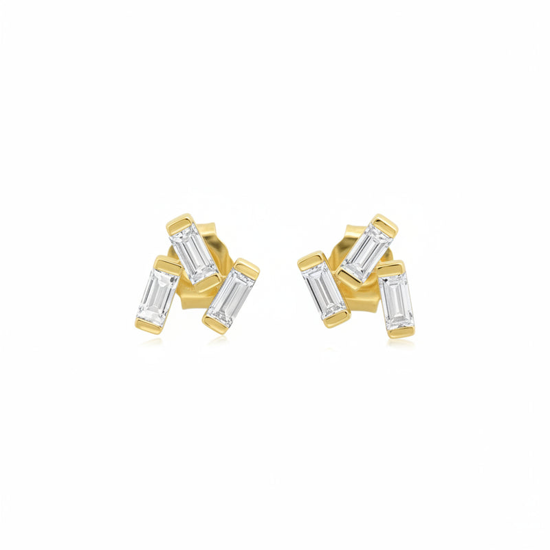 A pair of gold stud earrings with baguette-cut clear gemstones, shown from both the front and side angles against a white background with a faint diagonal watermark pattern.