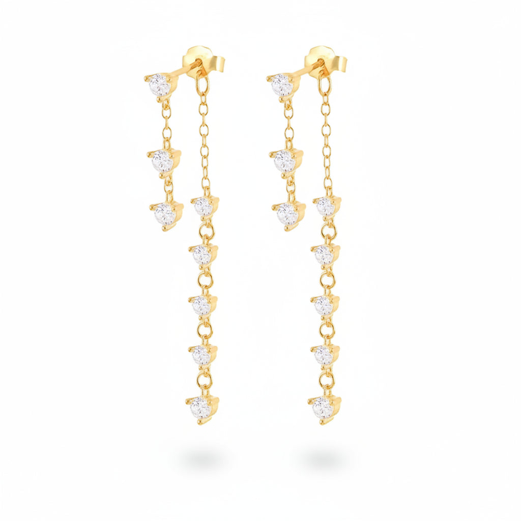A pair of gold dangle earrings with clear heart-shaped crystals, displayed on a white background with a repeating watermark.