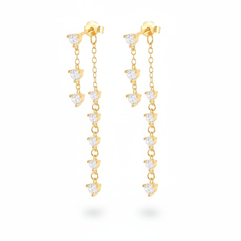 A pair of gold dangle earrings with clear heart-shaped crystals, displayed on a white background with a repeating watermark.