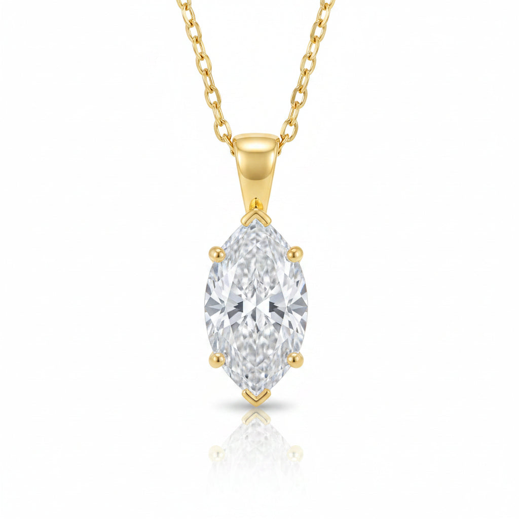 Gold necklace with a large diamond pendant on a lace background