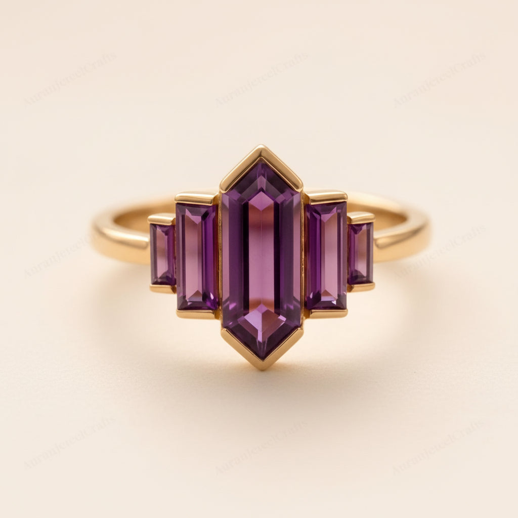 Gold ring with purple gemstones on a textured beige background