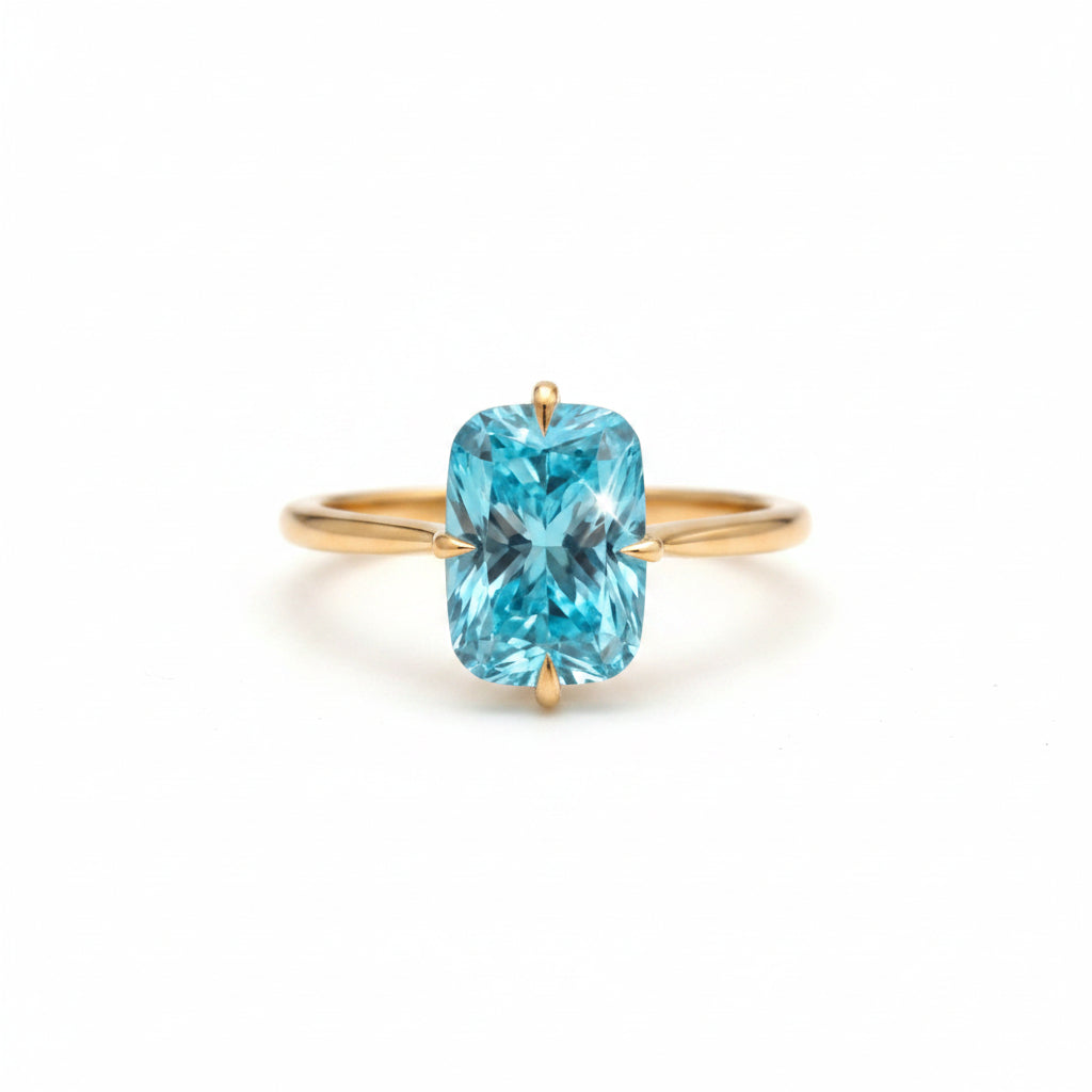A gold ring with a large, cushion-cut light blue gemstone, resting on an old, worn leather book cover against a warm brown background.