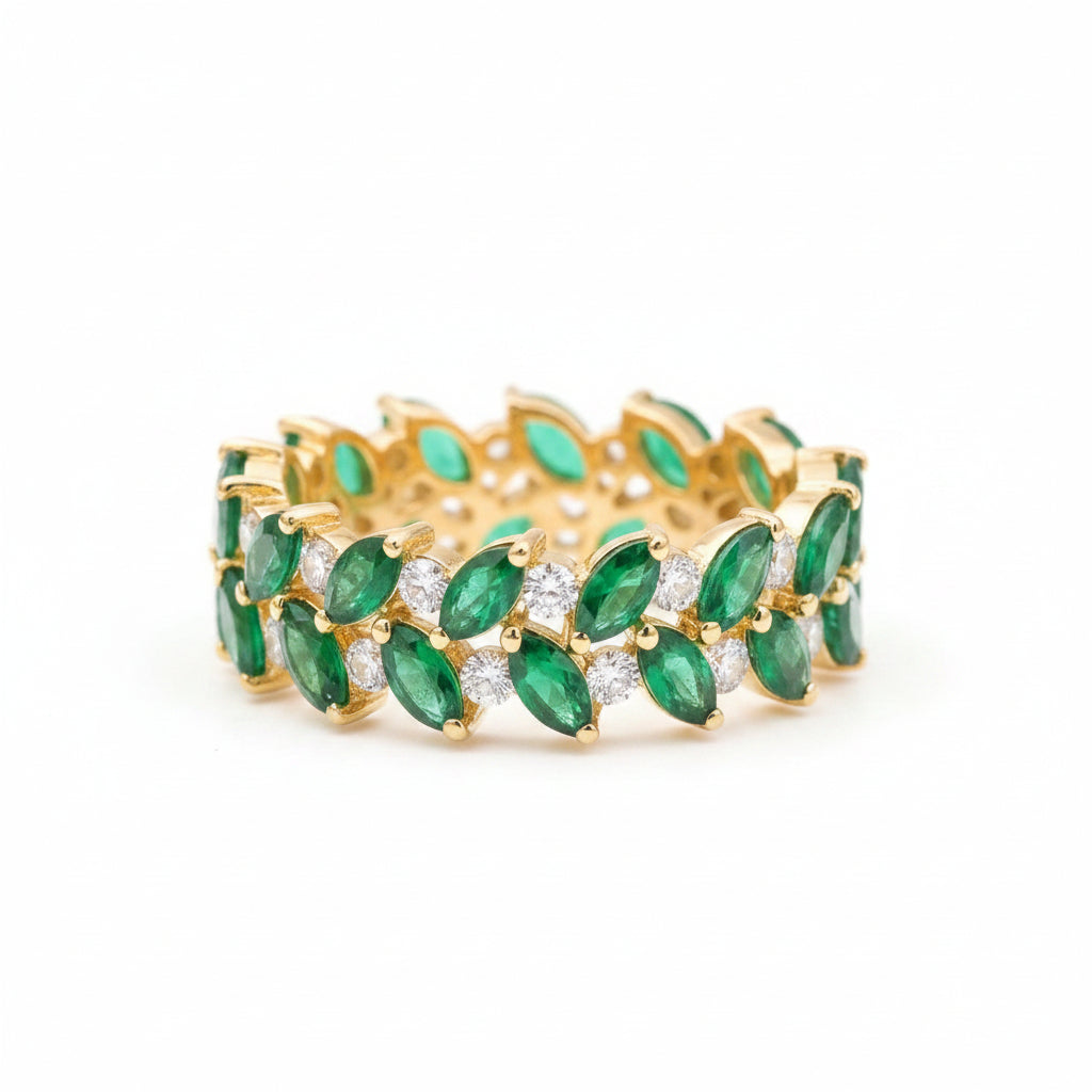 Gold bracelet with green gemstones on a textured surface