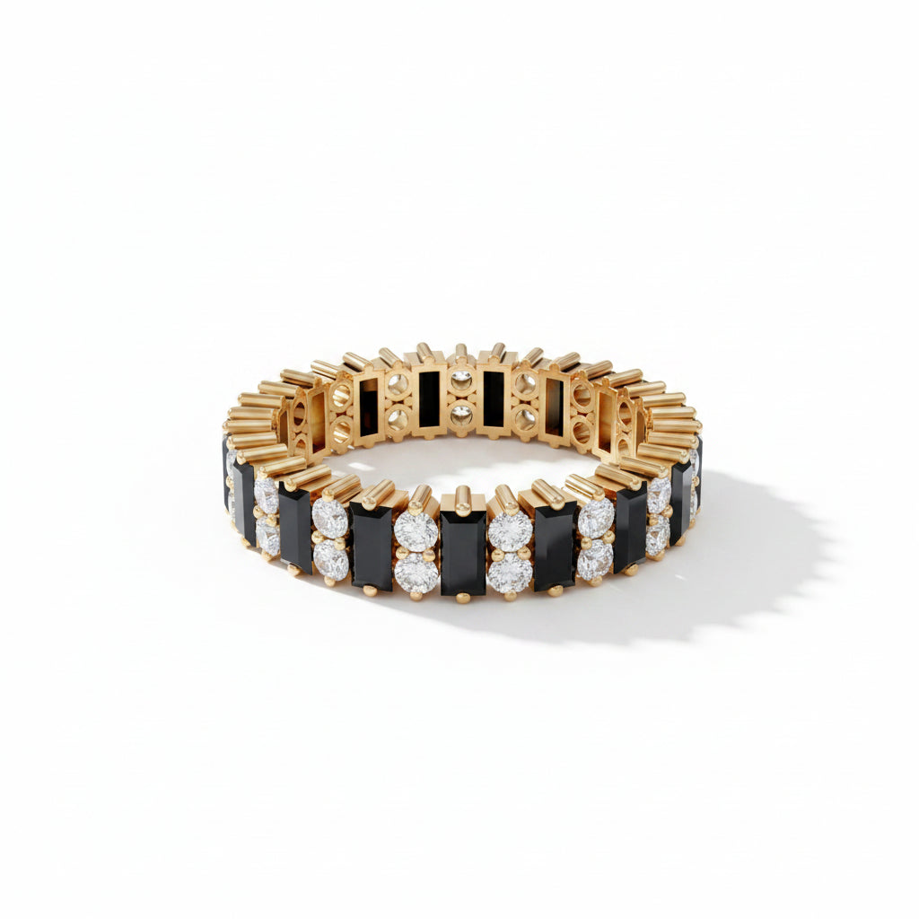 A gold-plated link bracelet with alternating black rectangular inlays and rows of clear round gemstones, displayed on a dark gray textured surface with geometric steps in the background.