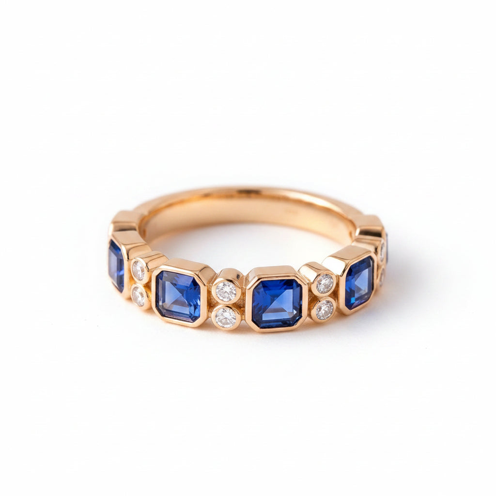Gold ring with blue gemstones on a textured fabric background