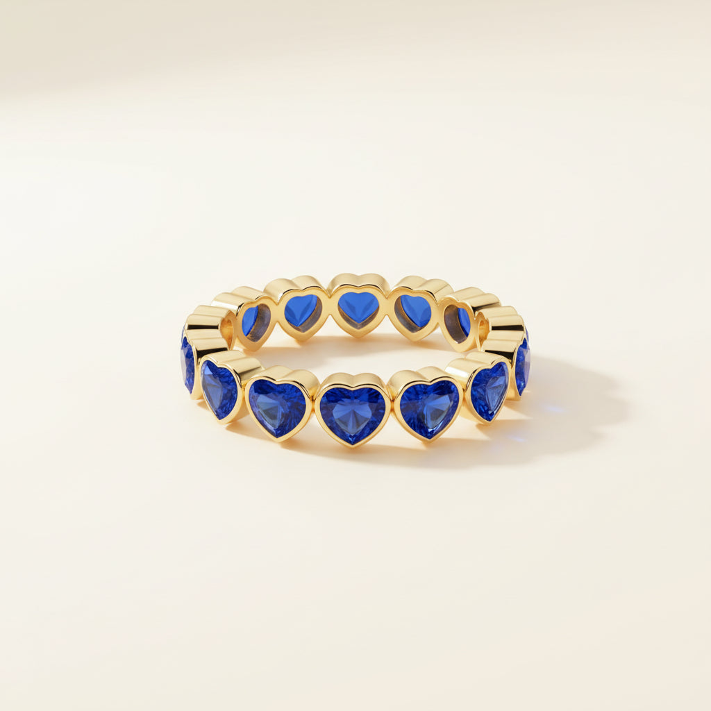 Gold ring with blue gemstones on a textured fabric background