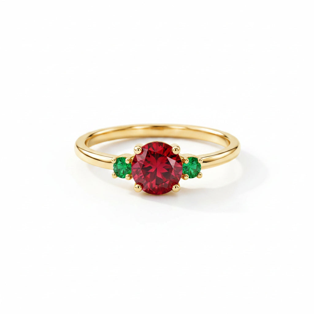 A gold ring featuring a large oval red gemstone in the center, flanked by two small round green gemstones, resting on a textured beige fabric background.