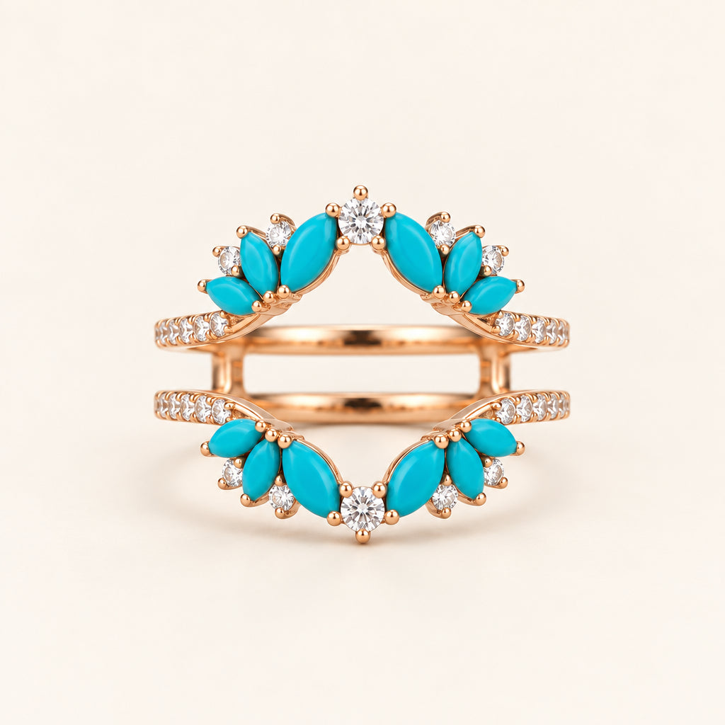 A rose gold double ring set with marquise-cut turquoise stones and small clear cubic zirconia accents, displayed on a white marble surface.