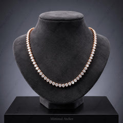 A double-row diamond tennis necklace in rose gold, displayed on a black velvet jewelry bust against a dark gray gradient background.